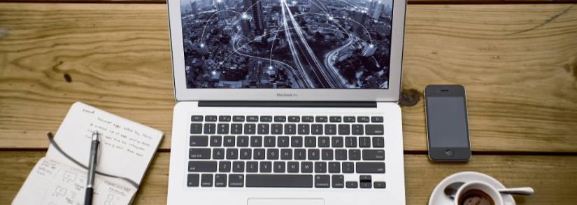 Laptop and notebook on wooden table